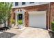 Charming brick home featuring a well-manicured lawn, attached garage, and a welcoming front entrance at 2945 Duvalla Ave, Charlotte, NC 28209