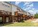View of condo community with wooden decks, brick foundations, and beautiful, blue skies at 2945 Duvalla Ave, Charlotte, NC 28209