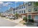 Townhouse boasts a brick and siding exterior, complemented by a driveway and verdant landscaping at 2945 Duvalla Ave, Charlotte, NC 28209