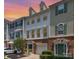 Charming townhome with brick and siding exterior with a warm sunset in the background at 2945 Duvalla Ave, Charlotte, NC 28209