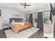 Inviting main bedroom features a neutral palette, hardwood floors, and many large windows at 2945 Duvalla Ave, Charlotte, NC 28209