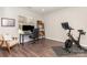 Office space offers a desk, exercise bike, wood floors, and natural light at 2945 Duvalla Ave, Charlotte, NC 28209