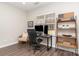 Bright home office featuring a desk, ergonomic chair, shelving, and wood-look flooring at 2945 Duvalla Ave, Charlotte, NC 28209