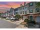 Charming townhomes with brick accents, garages, and inviting curb appeal on a tree-lined street at 2945 Duvalla Ave, Charlotte, NC 28209