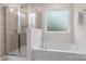 Bright bathroom featuring a walk-in shower and separate soaking tub with a large window at 3237 Yarmouth Ln, Gastonia, NC 28056