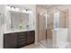 Bathroom featuring a double vanity, framed mirror, and a glass-enclosed shower at 3237 Yarmouth Ln, Gastonia, NC 28056