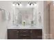 Bathroom featuring a double vanity with dark wood cabinets, bright lighting, and a glass-enclosed shower at 3237 Yarmouth Ln, Gastonia, NC 28056