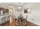 Bright breakfast nook with a glass table and seating for four, adjacent to the kitchen with counter seating at 3237 Yarmouth Ln, Gastonia, NC 28056