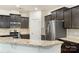 Modern kitchen boasts stainless steel appliances and granite countertops with dark brown cabinets at 3237 Yarmouth Ln, Gastonia, NC 28056