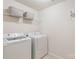 Convenient laundry room with modern washer and dryer, wire rack and ironing board at 3237 Yarmouth Ln, Gastonia, NC 28056