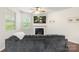 Cozy living room features a fireplace, large windows, and comfortable seating at 3237 Yarmouth Ln, Gastonia, NC 28056