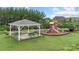 View of the community playground and picnic area with a gazebo in a grassy space at 3237 Yarmouth Ln, Gastonia, NC 28056