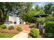 Outdoor space featuring a brick patio with a built-in grill and lush landscaping at 3250 Celanese Rd, Rock Hill, SC 29732