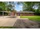 Charming brick home with a covered carport and well-maintained landscaping for convenient parking and curb appeal at 3250 Celanese Rd, Rock Hill, SC 29732