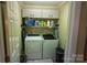 Functional laundry room equipped with a washer, dryer, and ample shelving for storage at 332 Daybrook Dr, Landis, NC 28088
