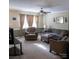 Comfortable living room with a ceiling fan, two large windows, and a relaxing sitting area at 332 Daybrook Dr, Landis, NC 28088