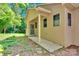 Back entrance featuring a porch, concrete walkway, and wooded yard at 3333 Roberta Rd, Concord, NC 28027