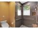 Modern bathroom featuring tiled walls, mosaic floor and safety bars in walk-in shower at 3333 Roberta Rd, Concord, NC 28027