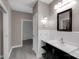 Hallway leading to bathroom featuring dark wood vanity, ample counter space, and updated finishes at 3333 Roberta Rd, Concord, NC 28027