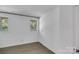 Well-lit bedroom with fresh paint, featuring two windows for ample natural light and modern flooring at 3333 Roberta Rd, Concord, NC 28027