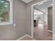 Hallway view leading to kitchen with wood-look flooring and light-filled ambiance at 3333 Roberta Rd, Concord, NC 28027