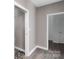 Neutral hallway featuring a sliding door and doorways with modern baseboards at 3333 Roberta Rd, Concord, NC 28027