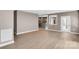 Open-concept living area with hardwood floors and a door leading outside at 3333 Roberta Rd, Concord, NC 28027