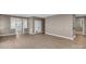Open-concept living room featuring light-colored walls, wood-look floors, and ample natural light at 3333 Roberta Rd, Concord, NC 28027