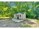 Outbuilding features a door, windows, and surrounding woods at 3333 Roberta Rd, Concord, NC 28027