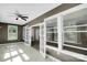 The sunroom features bright natural light, tile flooring, and a ceiling fan at 3333 Roberta Rd, Concord, NC 28027