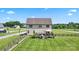 Aerial view of backyard featuring manicured lawn, deck, classic fencing and home at 3340 Emerald Pointe Ct, Monroe, NC 28110
