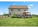 Brick home's backyard features a spacious deck with pergola, grassy area, and classic wooden fencing at 3340 Emerald Pointe Ct, Monroe, NC 28110