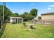 Spacious backyard featuring a chicken coop, wooden tables, and ample green space at 3340 Emerald Pointe Ct, Monroe, NC 28110