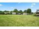 Sprawling backyard features verdant lawn, classic fencing, and outbuildings adding charm and functionality at 3340 Emerald Pointe Ct, Monroe, NC 28110