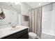 Clean bathroom with a single vanity, toilet, and shower-tub combination with a striped curtain at 3340 Emerald Pointe Ct, Monroe, NC 28110