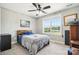 Comfortable bedroom with a queen bed, large window overlooking the yard, and ceiling fan at 3340 Emerald Pointe Ct, Monroe, NC 28110