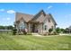 Charming brick home with a manicured lawn, complemented by mature trees and a spacious driveway at 3340 Emerald Pointe Ct, Monroe, NC 28110