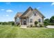 Charming brick home featuring a well-manicured lawn and inviting front porch, showcasing classic curb appeal at 3340 Emerald Pointe Ct, Monroe, NC 28110
