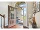 Open foyer with hardwood floors and views of the front porch, showcasing a welcoming entrance at 3340 Emerald Pointe Ct, Monroe, NC 28110