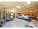Interior of garage space is equipped with work out equipment, car and lawnmower at 3340 Emerald Pointe Ct, Monroe, NC 28110