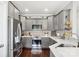 Well-lit kitchen with stainless steel appliances, gray cabinets, subway tile backsplash, and hardwood flooring at 3340 Emerald Pointe Ct, Monroe, NC 28110