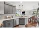 Open kitchen with stainless appliances, gray cabinets, and eat-in area with view of the dining room at 3340 Emerald Pointe Ct, Monroe, NC 28110