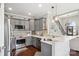 Modern kitchen with stainless steel appliances, gray cabinetry, quartz countertops, and breakfast bar at 3340 Emerald Pointe Ct, Monroe, NC 28110