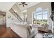 Bright living room featuring hardwood floors, large windows, and a cozy seating area at 3340 Emerald Pointe Ct, Monroe, NC 28110