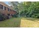 View of the home's backyard with mature trees and landscaping at 3420 Long Ferry Rd, Salisbury, NC 28146