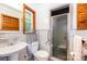 Bright bathroom boasts white fixtures, window, and glass-enclosed shower at 3420 Long Ferry Rd, Salisbury, NC 28146