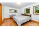The primary bedroom has three windows, wood floors, and neutral walls at 3420 Long Ferry Rd, Salisbury, NC 28146