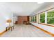 Bright living room featuring a brick fireplace, built-in shelving, and large windows at 3420 Long Ferry Rd, Salisbury, NC 28146