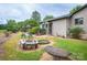 Cozy backyard featuring a fire pit, stone table, green door entrance, and gazebo at 40 Old Rd, Taylorsville, NC 28681