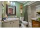 Well-maintained bathroom features a shower-tub combo, classic vanity, and soft, green wall color at 40 Old Rd, Taylorsville, NC 28681